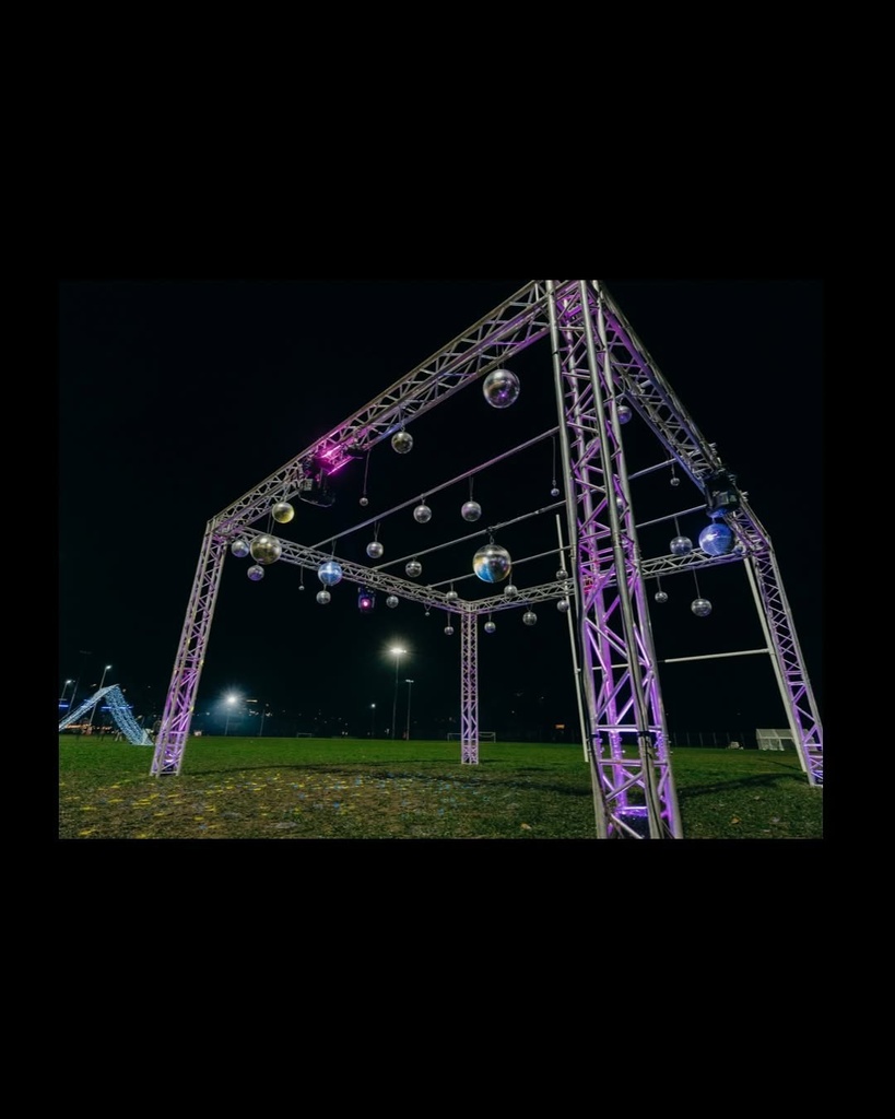 Aluminium truss structure rigged with mirror balls at an outdoor event